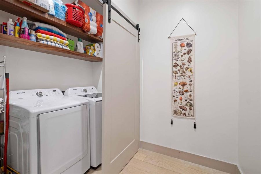 The laundry room is equipped with ample storage, ensuring efficient laundry routines in a stylish setting.