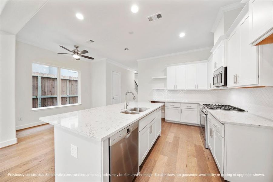 The kitchen seamlessly flows into a sizable breakfast room, lined with windows that fill the space with natural light, creating the perfect spot for morning meals and casual dining.