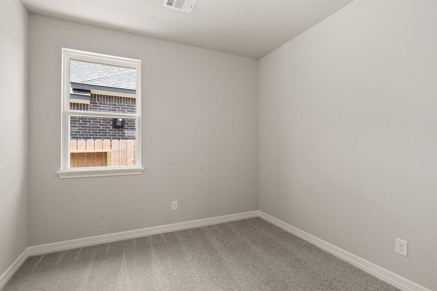 Your secondary bedroom features plush carpet, fresh paint, closet, and a large window that lets in plenty of natural lighting.