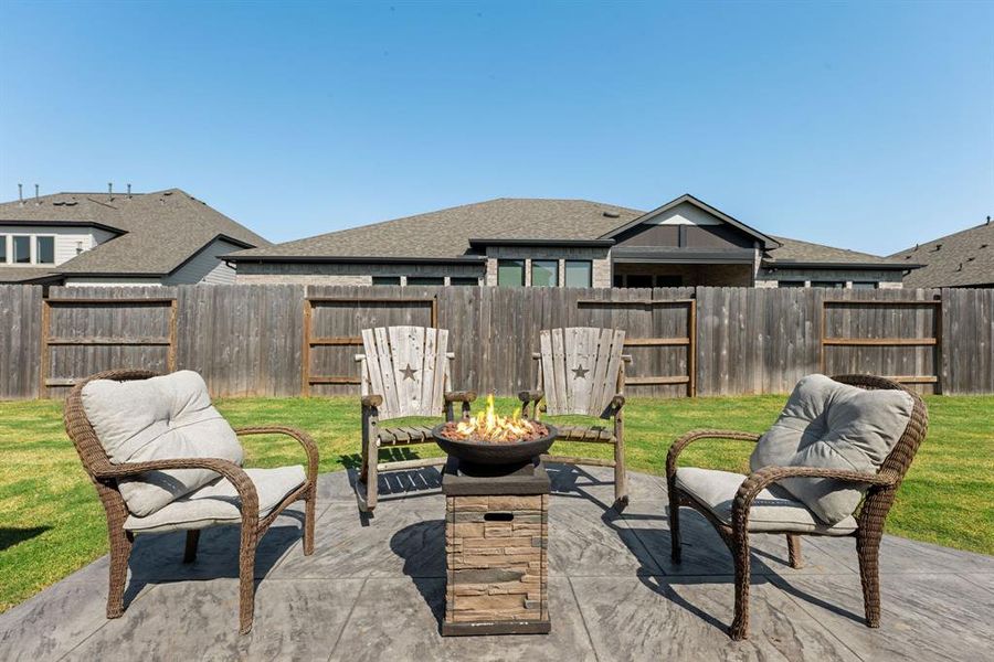 Step into your private outdoor oasis, perfect for relaxing and entertaining. This expansive backyard features a cozy fire pit surrounded by stylish seating, ideal for evening gatherings under the stars.