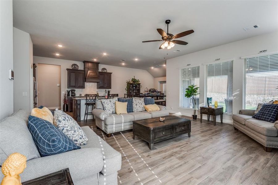 Living room with light wood-type flooring and ceiling fan