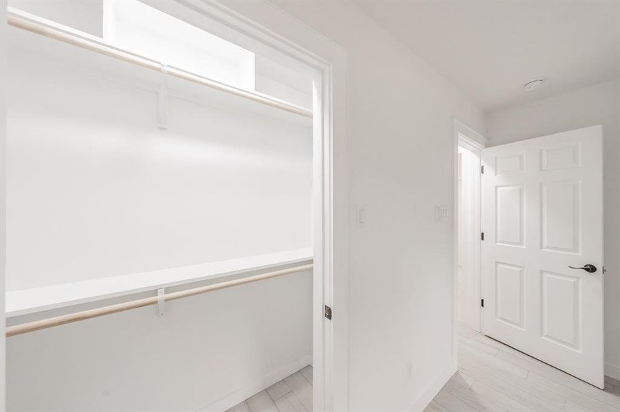 Spacious closet with light wood-type flooring