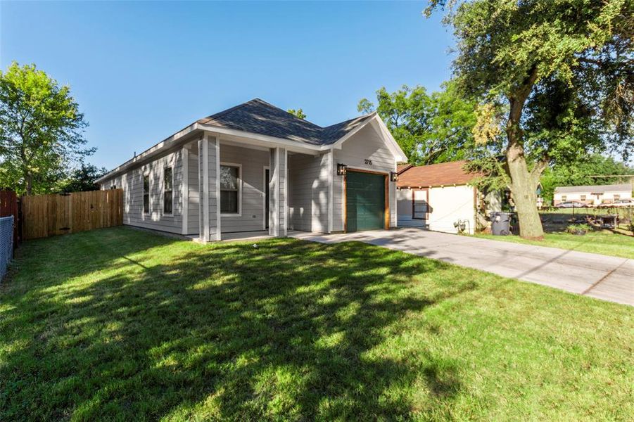 Ranch-style house with a front yard and a garage