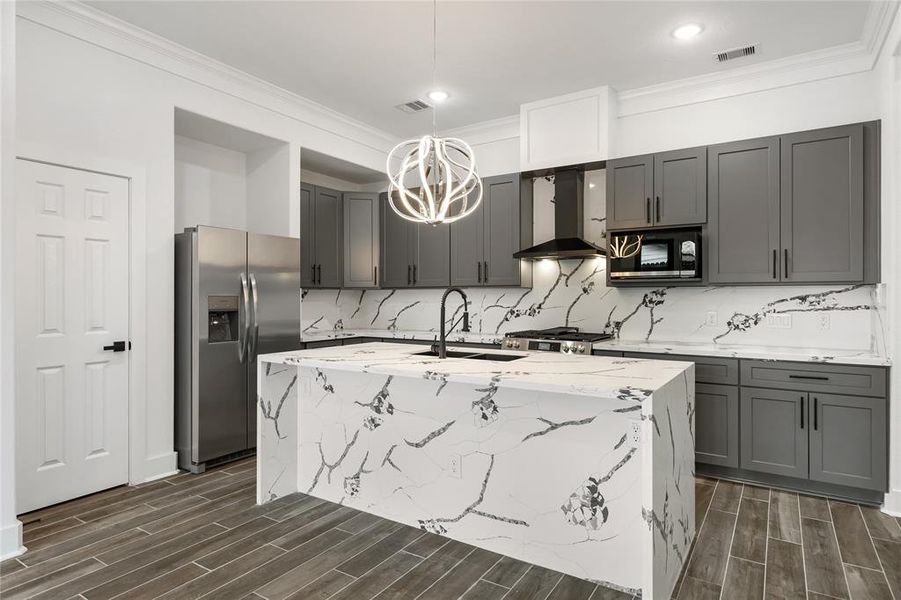 Making a bold statement in the Kitchen, the waterfall island and backsplash are absolutely striking!