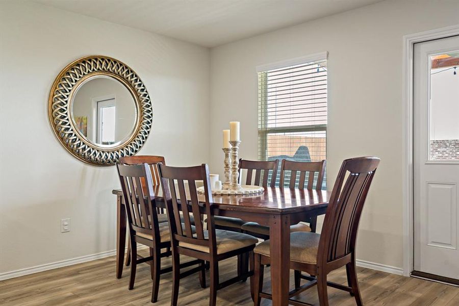 The kitchen features plenty of seating options, whether at the kitchen island or in the adjacent breakfast room.