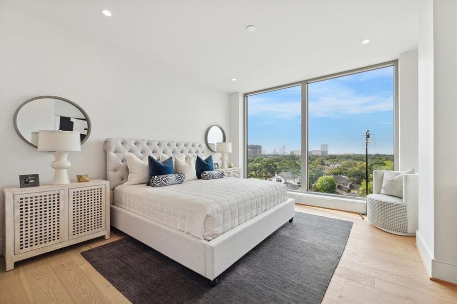 Step into luxury in the primary bedroom, where floor-to-ceiling windows invite natural light to dance across elegant furnishings. Wake up to panoramic views and bask in the beauty of each sunrise and sunset.
