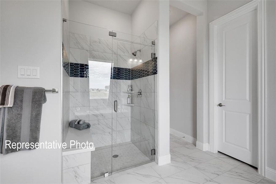Bathroom featuring a shower with shower door and tile floors