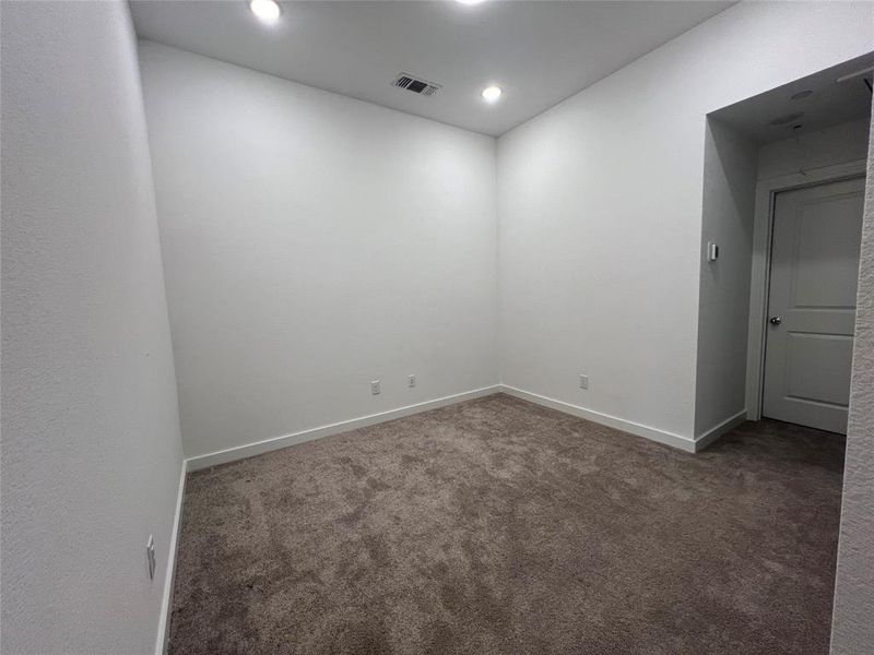 Unfurnished room with dark carpet