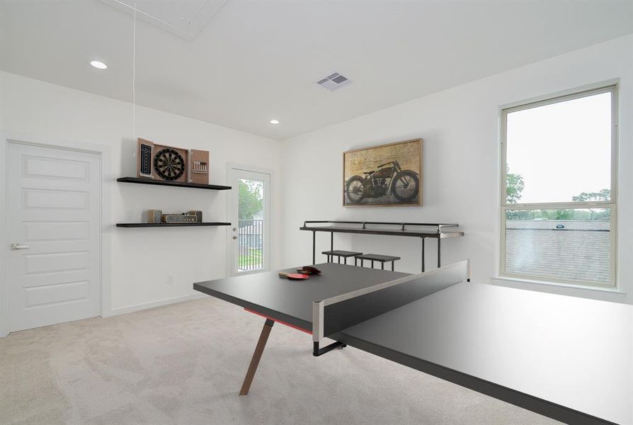 Ascend to the second-floor landing from this staircase, where a welcoming game room area awaits, complete with plush carpet and a stylish private balcony.