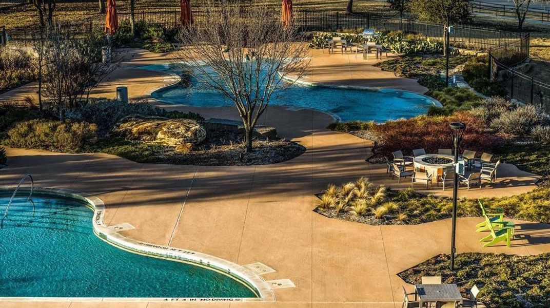 View of swimming pool featuring an outdoor fire pit and a patio area