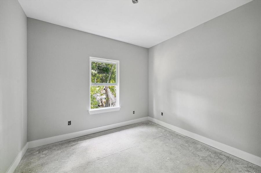 Secondary bedroom located on the second floor overlooks the backyard.