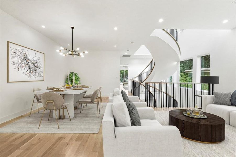 Living room featuring a notable chandelier and light wood-type flooring