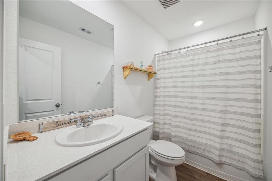 Secondary Bathroom also upgraded with quartz countertops.