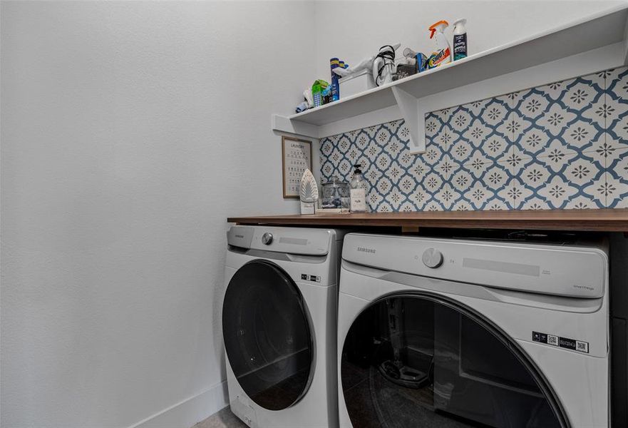 Laundry room featuring washer and clothes dryer