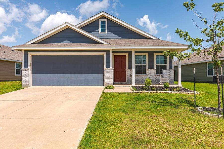 Craftsman inspired home with a front yard, a porch, and a garage