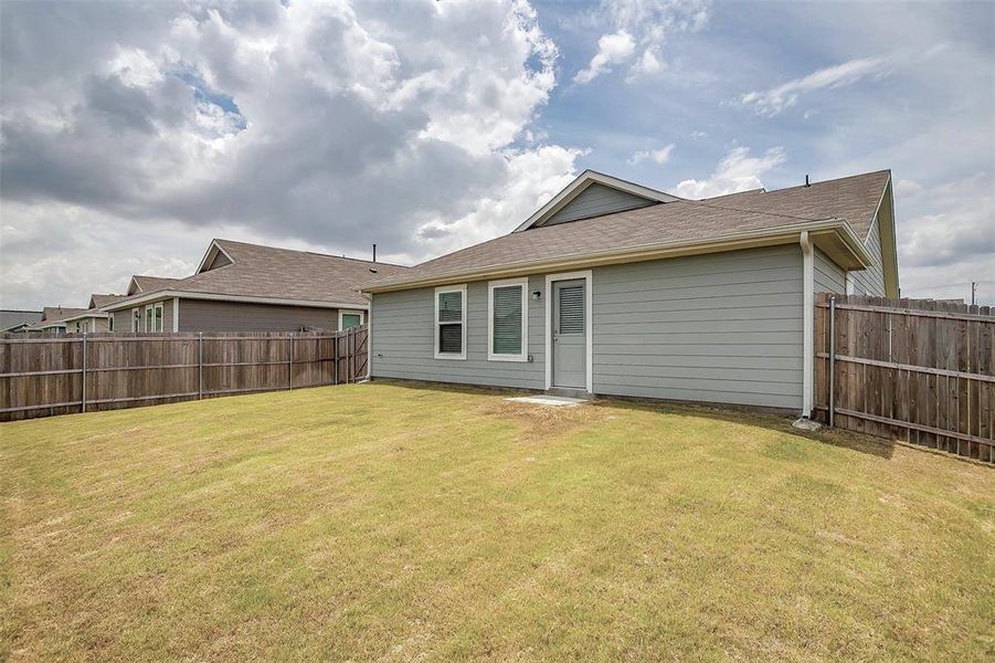 Rear view of house with a lawn