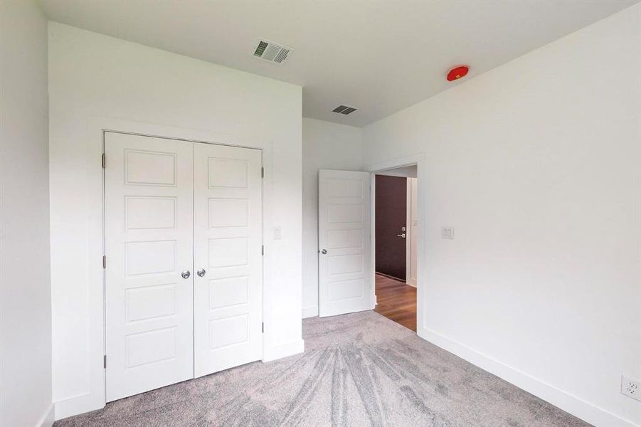 Unfurnished bedroom featuring a closet and carpet floors