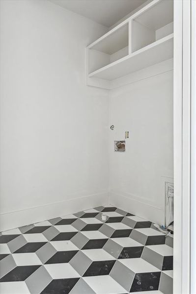 The addition of the geometric tile to the laundry room greatly enhances the overall aesthetic appeal of the space.