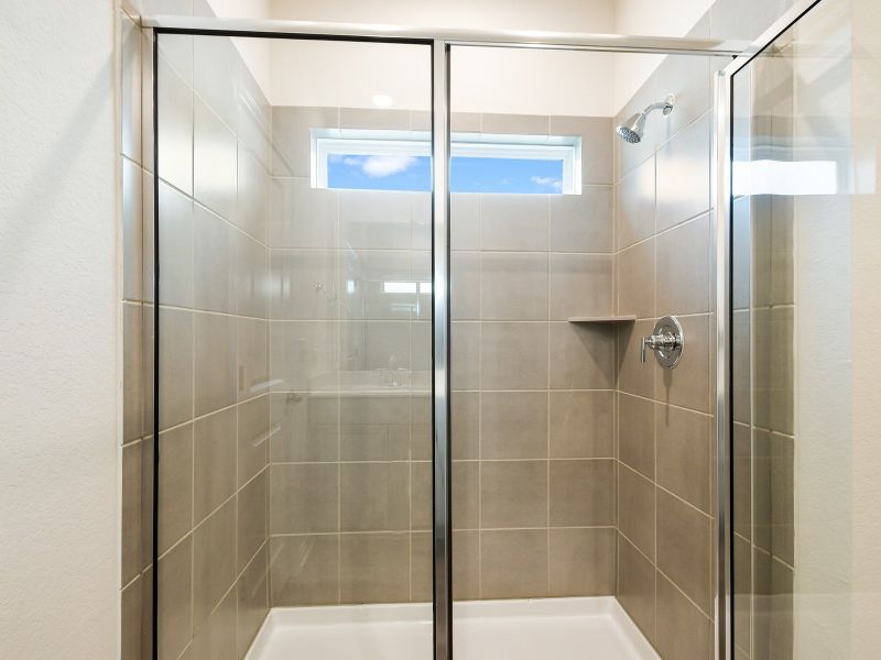 The primary bathroom comes with a walk-in shower.