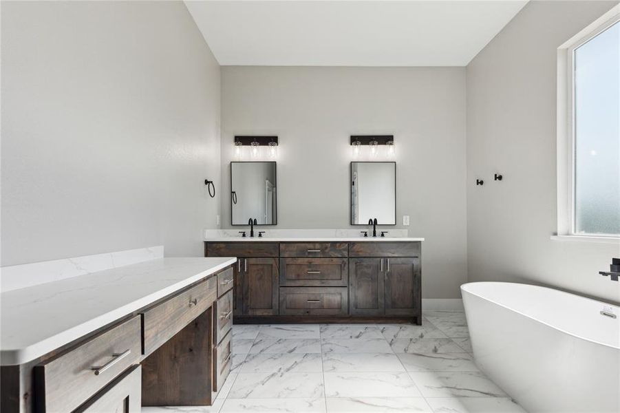 Bathroom featuring plenty of natural light, tile flooring, oversized vanity, and double sink