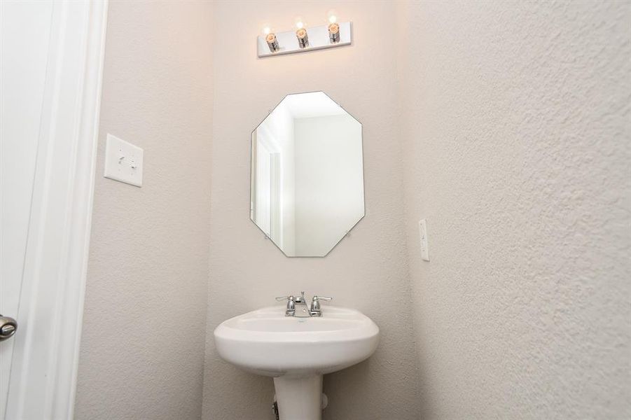 Half Bath with sleek pedestal sink