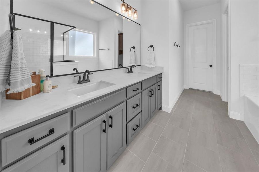 Bathroom featuring vanity, tile patterned flooring, and separate shower and tub