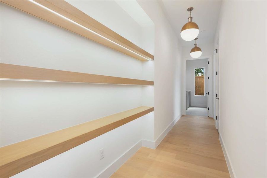 Corridor with light hardwood / wood-style floors