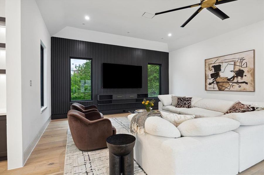 View of the Upstairs Game Room with wall mounted TV, ceiling fan and recessed LED lighting