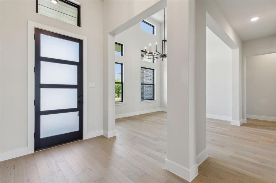 Foyer featuring an inviting chandelier and light hardwood / wood-style floors