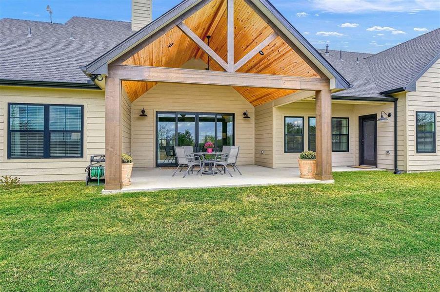 Back of property featuring a patio and a yard