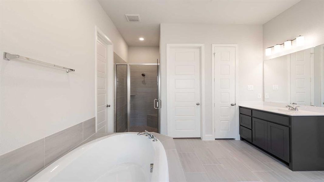 Bathroom with vanity, tile patterned floors, and separate shower and tub