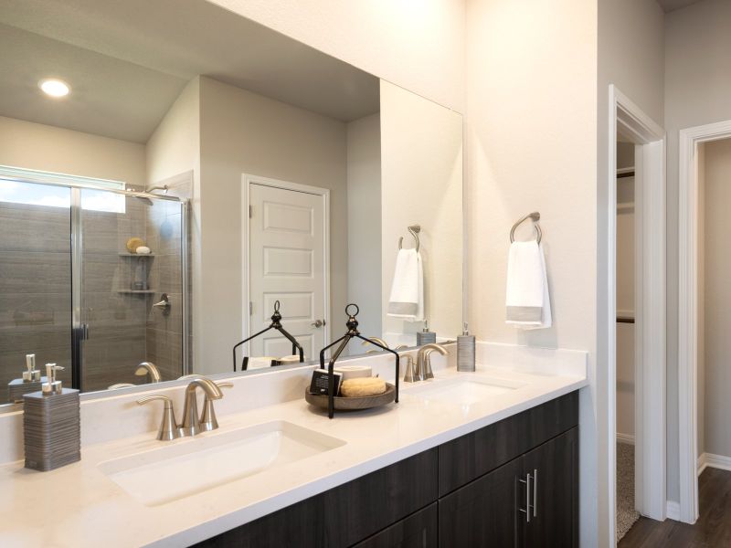 Enjoy dual sinks and oversized walk-in showers in your new primary bathroom.