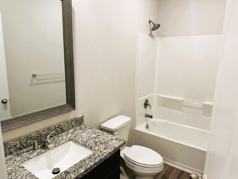 Bath 2 includes granite counters, framed mirror & ceramic tile tub/shower walls