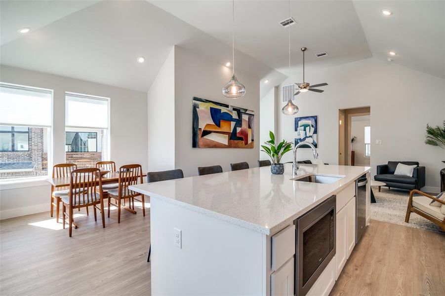 The dining area is shown in this view along with the microwave oven and diswasher.