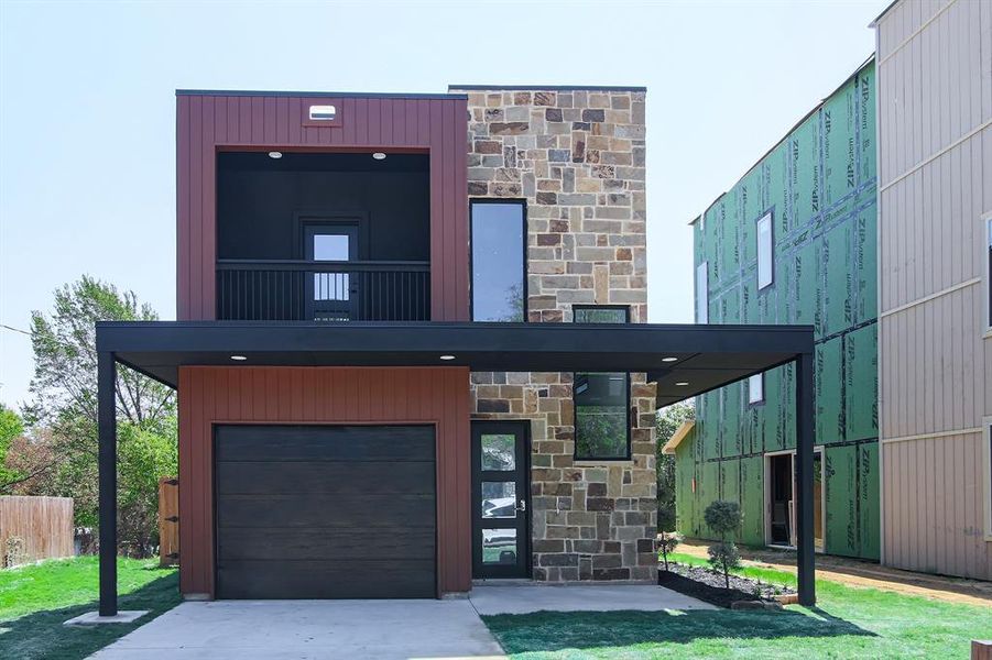 Contemporary home with a garage and a front lawn