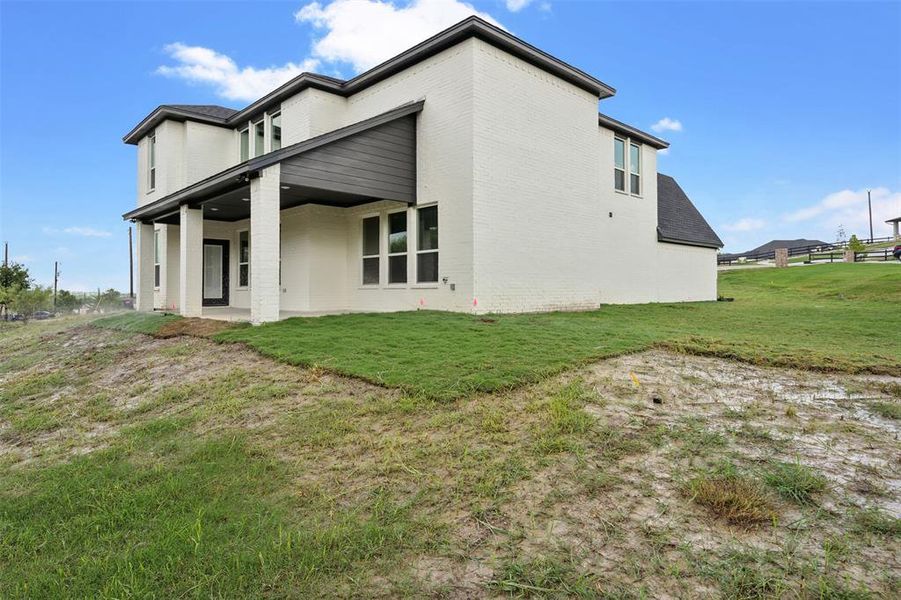 Rear view of property featuring a patio area and a yard