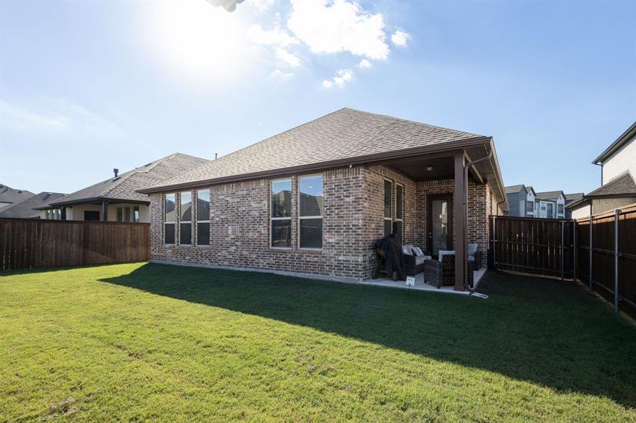 Rear view of house featuring a yard and a patio