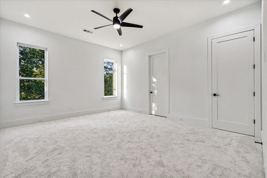 Spare room with light carpet and ceiling fan