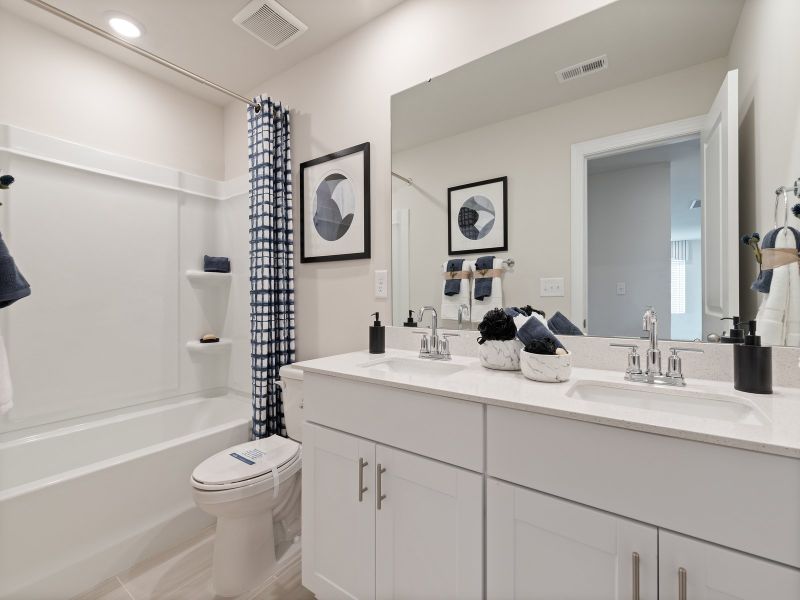 The secondary bathroom boasts dual sinks making early mornings a breeze.