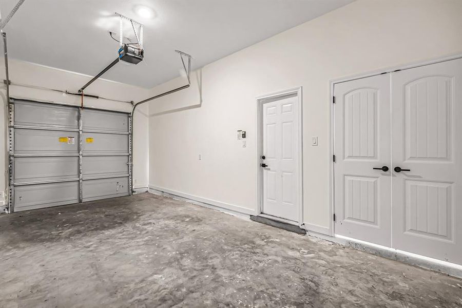 Garage space with double door storage closet.