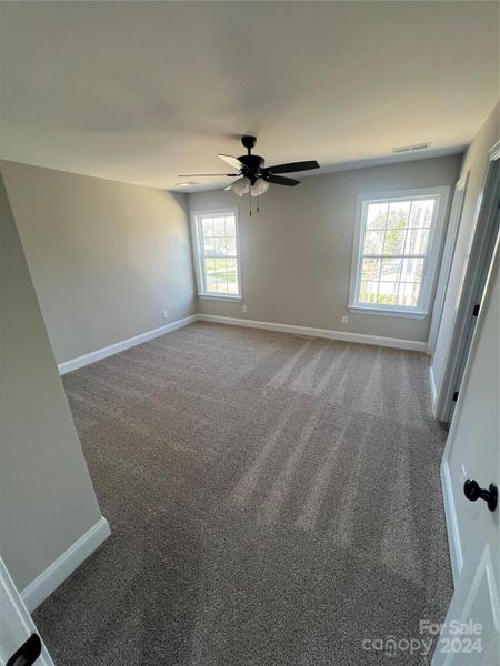 Spacious primary bedroom w/ walk-in closet.