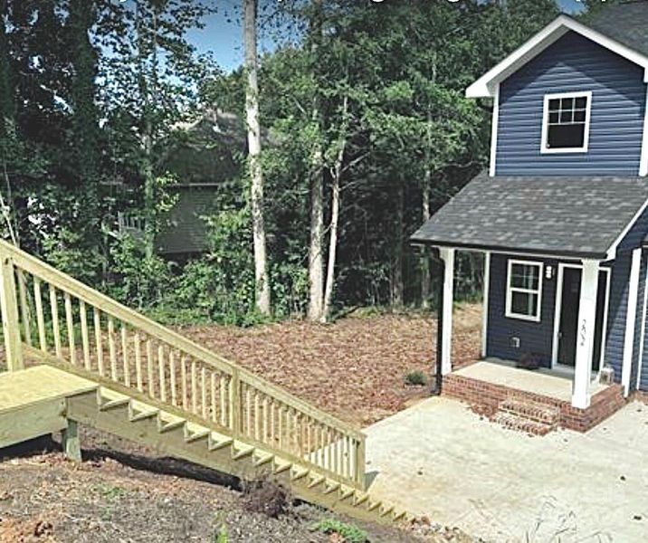 Custom stairs lead guests to the welcoming front porch