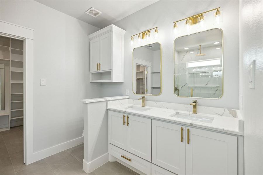 Bathroom featuring vanity, walk in shower, and tile patterned floors