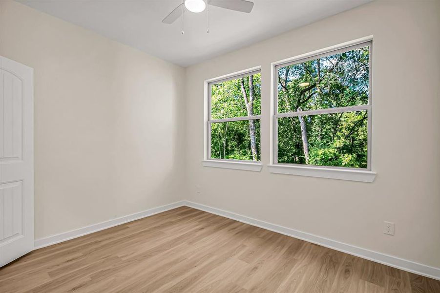 Guest bedroom on the second floor is bright and overlooks the backyard.