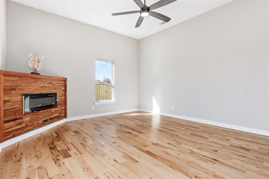 Unfurnished living room featuring light hardwood / wood-style flooring and ceiling fan