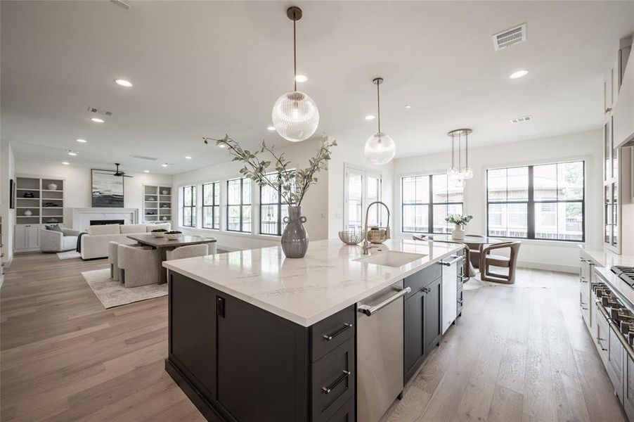 Discover the elegance of open-concept living with a sleek kitchen island featuring dual dishwashers, perfect for seamless entertaining and convenience.