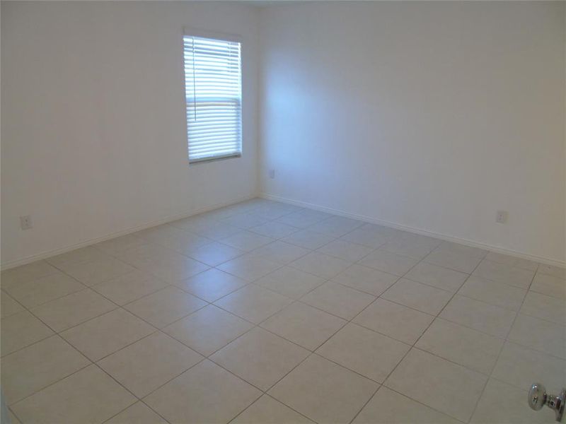 Empty room with light tile patterned floors