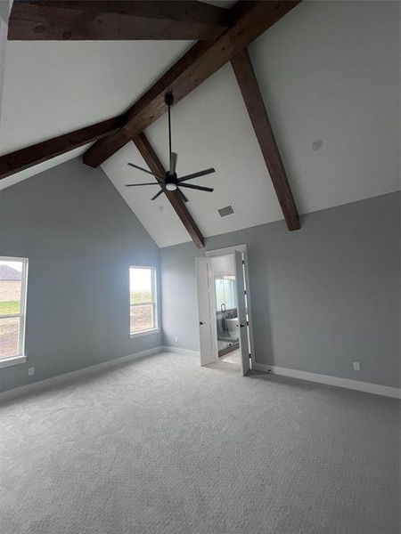 Carpeted spare room featuring beamed ceiling, high vaulted ceiling, and ceiling fan