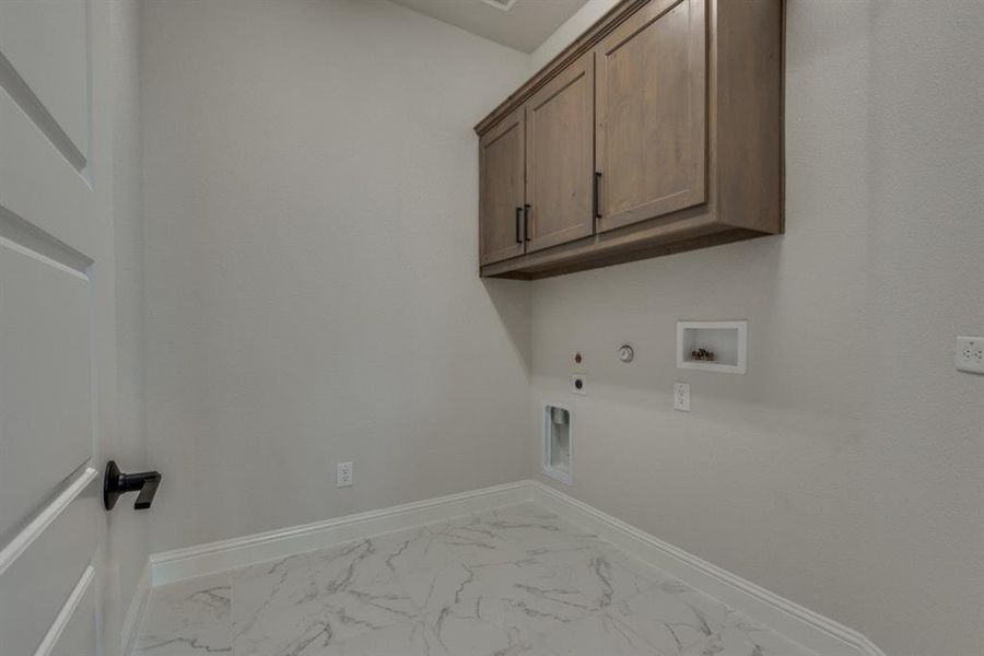 Spacious laundry room with secondary laundry in primary closet.