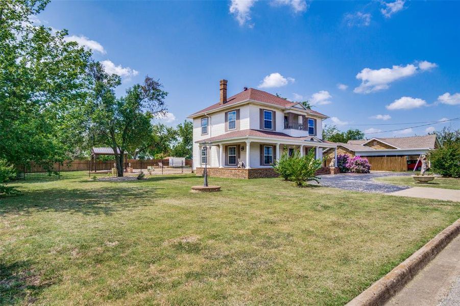 View of front of house featuring a gazebo and a front lawn